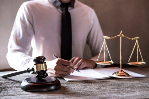 Close up of businessman with gavel and pen