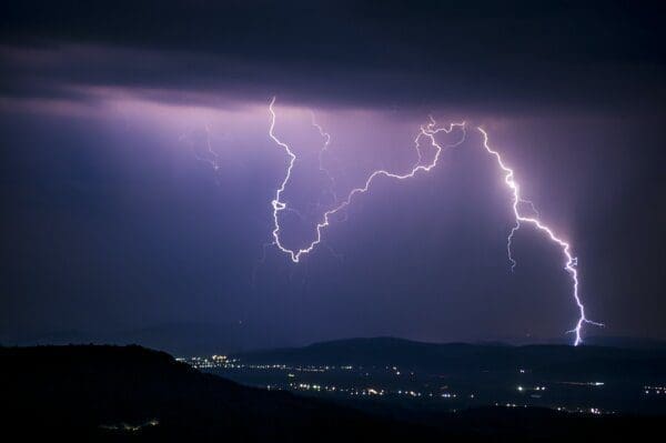 Lightning across a dark sky above a city