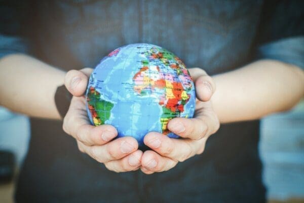Man holding globe Close up of man's hands holding a small globe