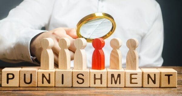 Punishment spelt out in wooden blocks with figures on top