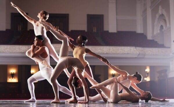 A group of ballet dancers performing in a theatre