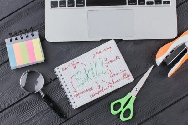 Skills written on a notepad on a desk with stationary