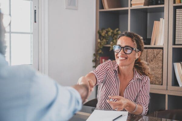  manager handshake hire male candidate at job interview