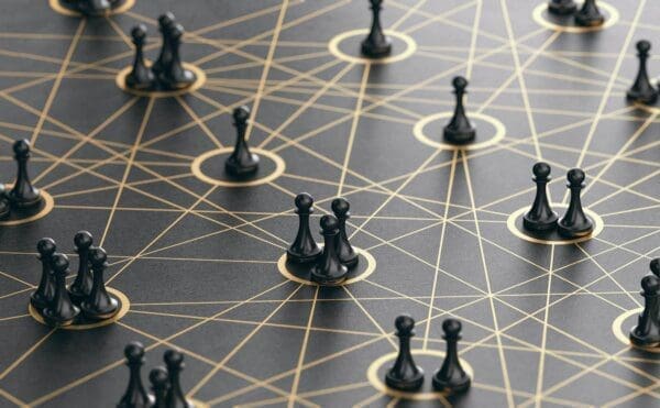 Groups of connected black pawns represent interpersonal communication