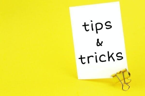 Tips & tricks on white sticker with paper clip on yellow background