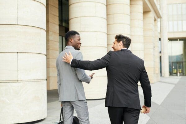 Two businessmen walking down the street in the city