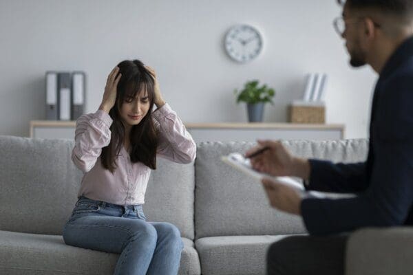 Upset woman seeking professional help at psychotherapist's