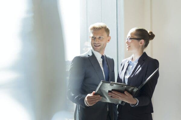 Businessman and businesswoman preparing for meeting