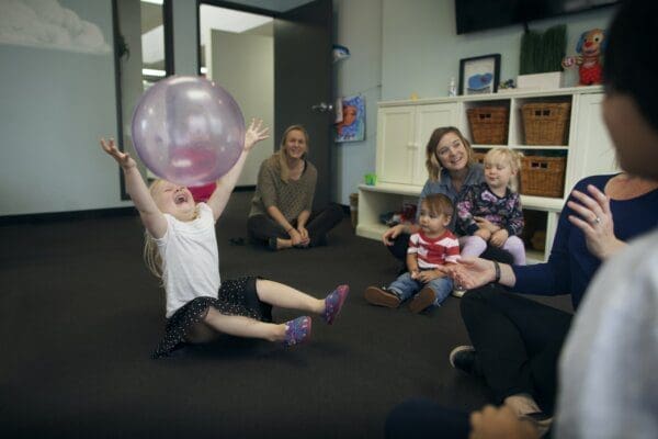 Children playing in a circle at a preschool