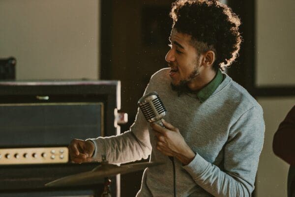 ENFJ African American singer performing song with a microphone