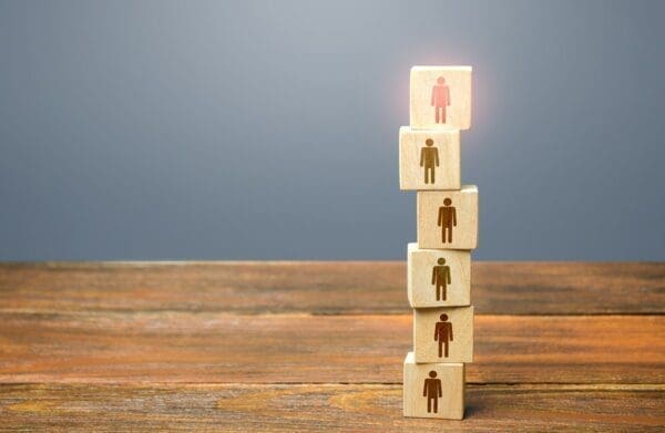 Block figures piled up with one lit up on top