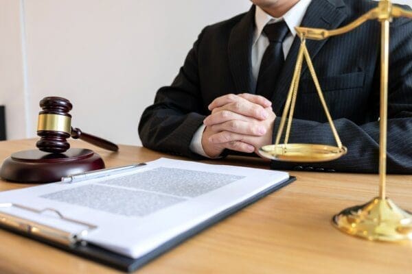 Judge behind a desk with a gavel and a contract