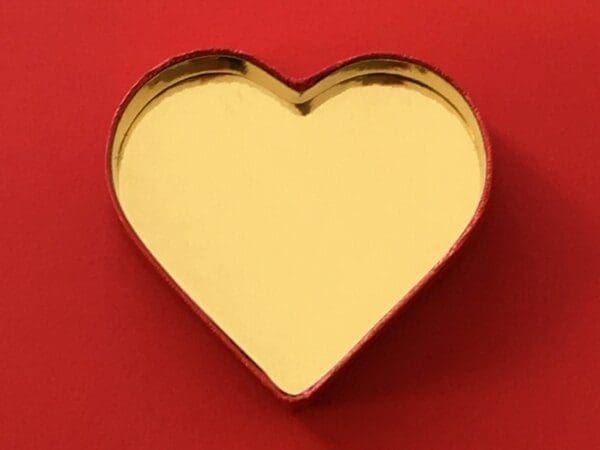 Gold heart A gold heart on a red background