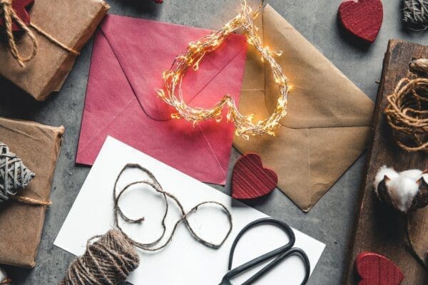 Light up heart laid on a table with envelopes and stationery