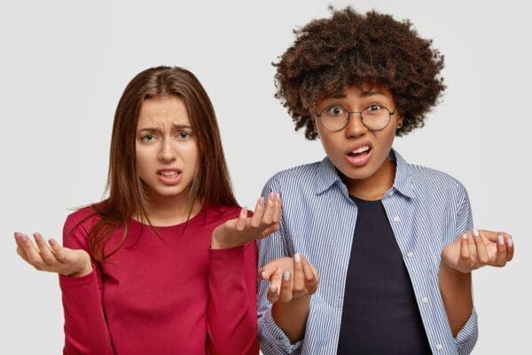 Two INTP young women with uncertain displeased expressions