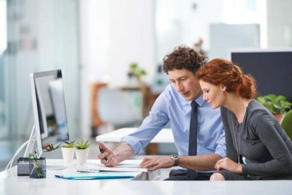 Work colleagues Young business professionals discussing work documents