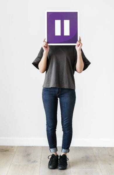 Pause icon Girl holding a purple pause icon sign to hide her face