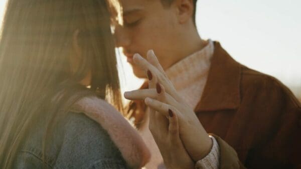In love couple Close up of a couple touching foreheads with interlinked fingers
