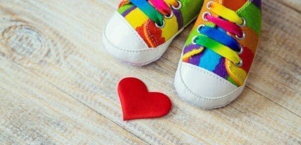 colourful shoes of an ISFJ and a love heart on a light wooden floor