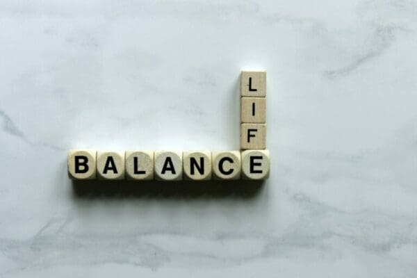 Life Balance Life Balance spelled with wooden cubes on a white marble surface