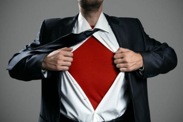 superhero power Businessman tearing his shirt open to show a superhero costume