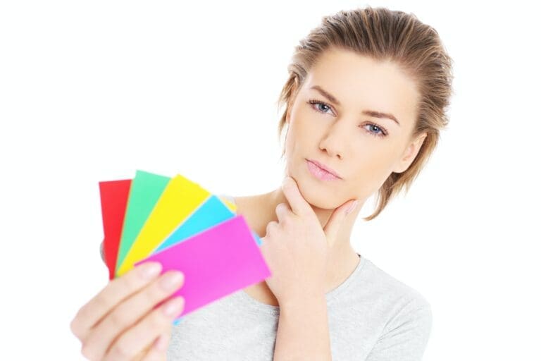 styles Lady holding colourful cards which represents strategic leadership styles