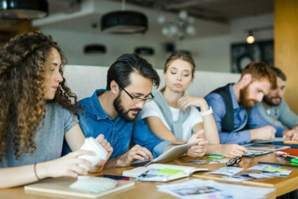 Male coworker displaying creative leadership with his team