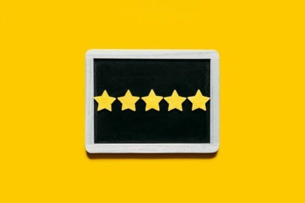 Five star rating on a black board with yellow background for excelling