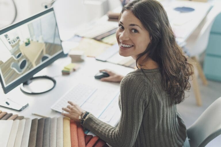 smiling Smiling female coworker at desk shows positive body language