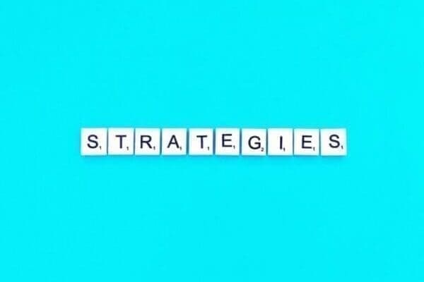 strategies spelt with white word scramble tiles on light blue background