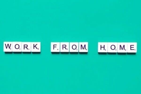 Work from home Work from home spelt with white tiles on light blue background