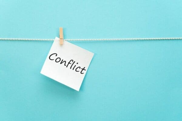 Clipped Note with the word conflict and blue background