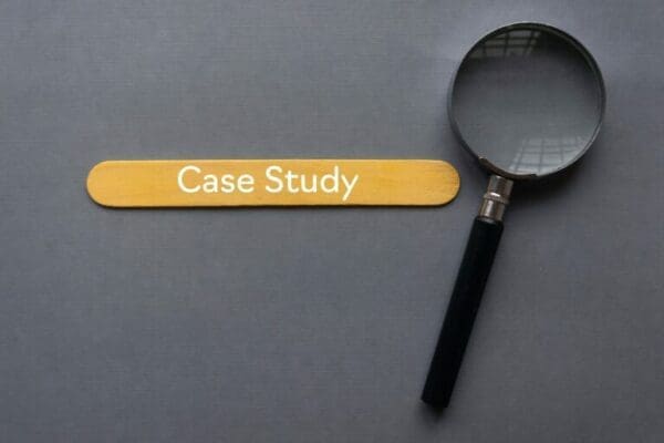 Case study phrase next to magnifying glass on grey background
