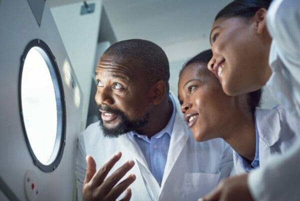 Group of employees looking through a window