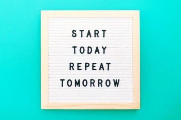 Start today Repeat tomorrow Quote on blue background