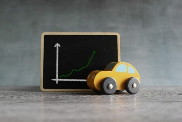 Toy car next to upward graph representing drivers for employee retention strategies