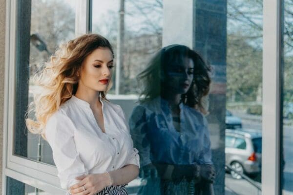Businesswoman walking Businesswoman with a disorder walking by a glass wall