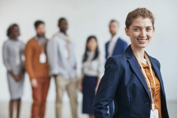 Young Female team Leader with Business Team behind her