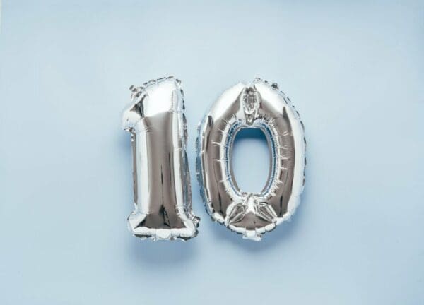 Silver balloon number 10 on light blue background