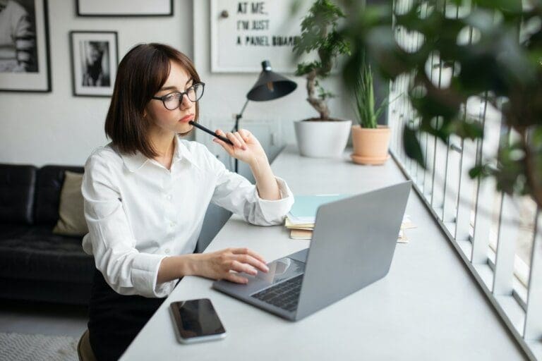 Young woman freelancer thinking Young woman freelancer thinking on how to get more done