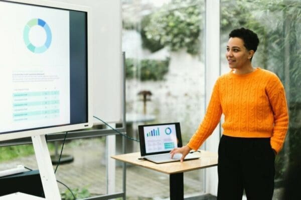 Female manager using Microsoft PowerPoint with laptop