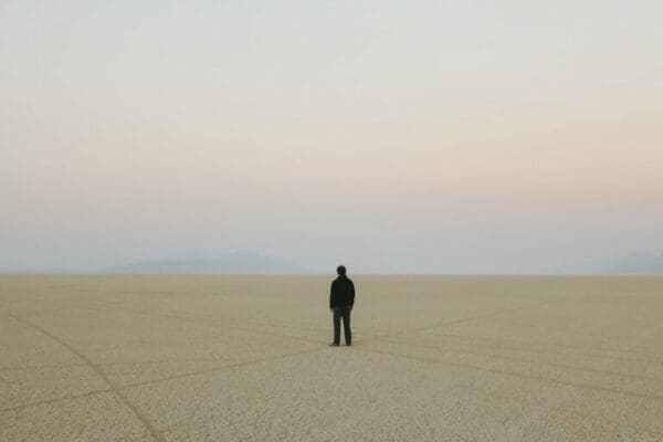 Man standing in vast, desert landscape