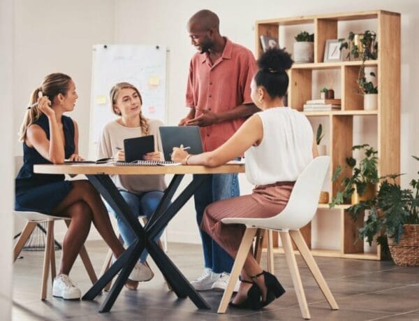 Team of employees with coach during team coaching