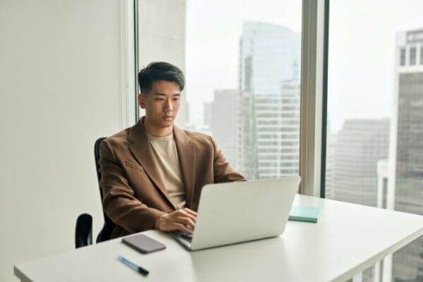 Busy businessman Busy businessman working on a laptop in office before the deadline