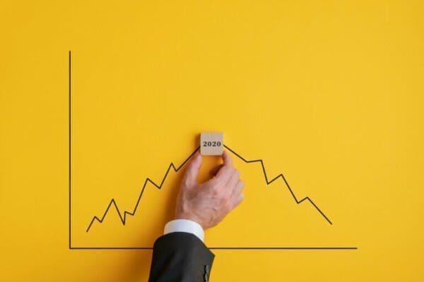 Hand with wooden cube on graph for 2021 Predictions