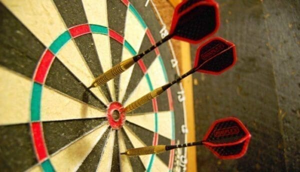 Dartboad with three red darts