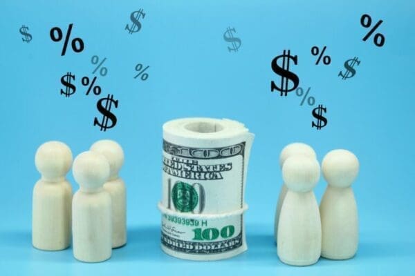 People vs profit Wooden figures surrounding roll of money with question marks above.
