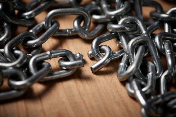 Chain with broken part Chain with broken part on wooden surface for chasing buyer