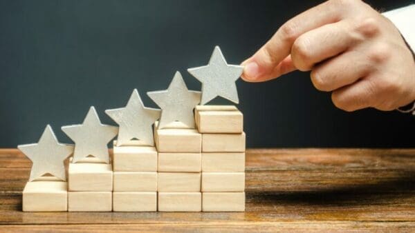 ranking stars Hand of man ranking stars of clients for consultative selling