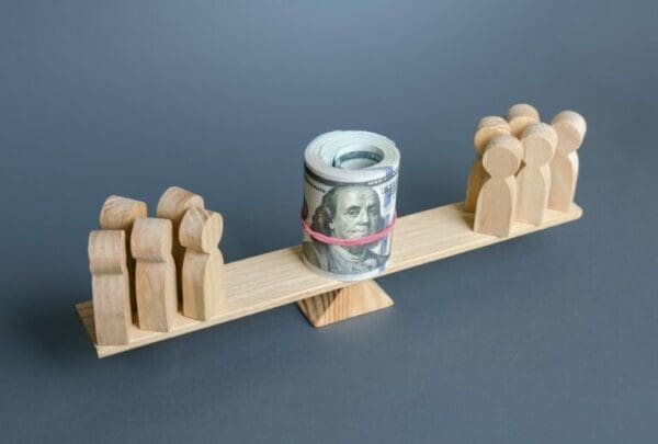 competing for funding Groups of wooden people are competing for funding representing supermarket war
